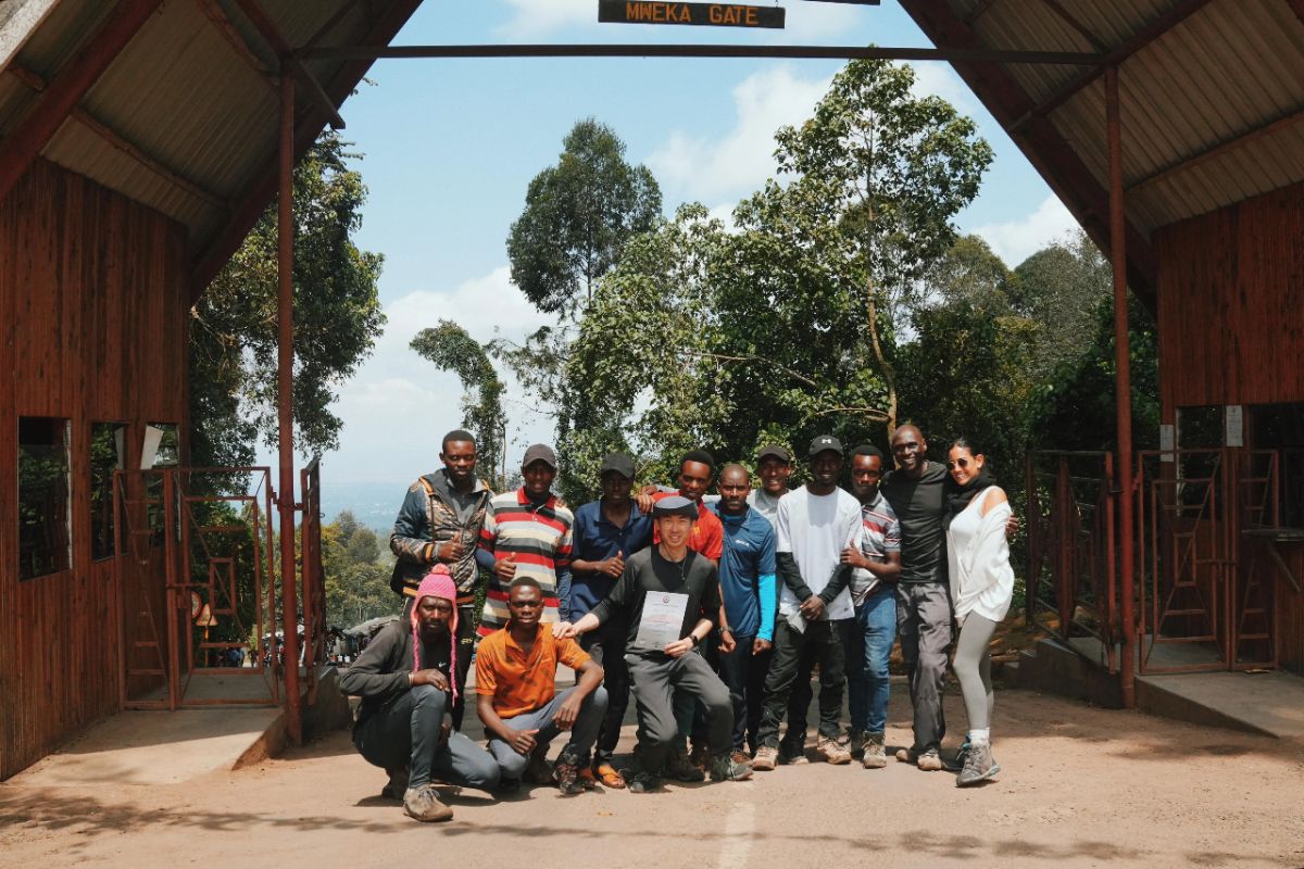 The entire crew after successfully reaching the summit of Kilimanjaro and celebrating with their tip.