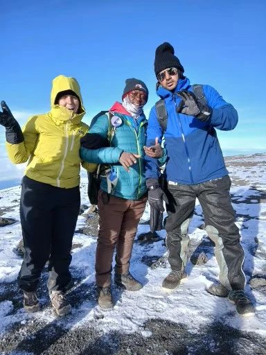 A lead Guide at mount Kilimanjaro top with our customers.